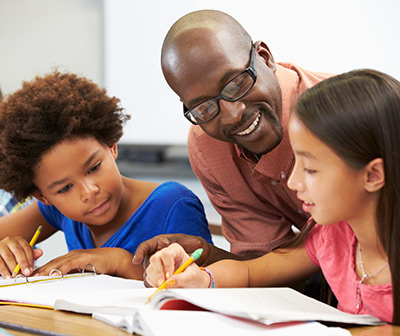 picture of teacher with elementary school students